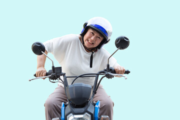 Fototapeta na wymiar Senior Asian woman riding motorcycle isolated on light blue background, Happy active old age and lifestyle concept