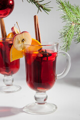 Two glass glasses with mulled wine on a winter background