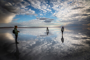 photographer boy on bicycle and stroller on a salt lake
