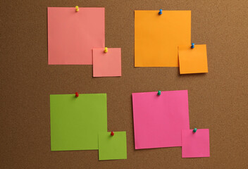 Colorful paper notes pinned to cork board
