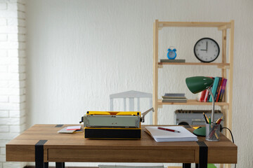 Vintage old typewriter at wooden desk table. Writer or screenwriter concept