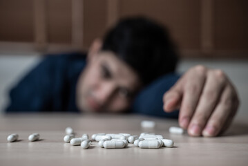 the person using drug overdoses lying on the table. close up on pills