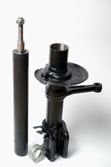 Car spare parts. Car front shock absorber. Contrasting photo on a white background. Front strut hydraulic shock absorber