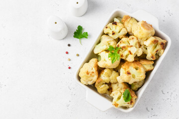 Buffalo cauliflower bites in baking dish. Space for text, top view.