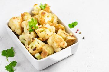 Vegan beer battered cauliflower in baking dish. Space for text.