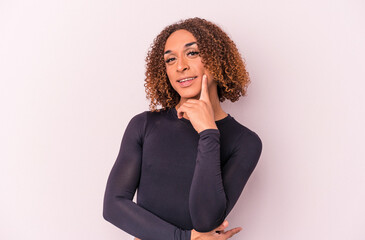 Young latin transsexual woman isolated on pink background smiling happy and confident, touching chin with hand. - obrazy, fototapety, plakaty