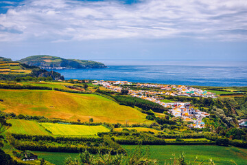 Fototapeta na wymiar Azores panoramic view of natural landscape, wonderful scenic island of Portugal. Beautiful lagoons in volcanic craters and green fields. Tourist attraction and travel destination. Azores, Portugal.