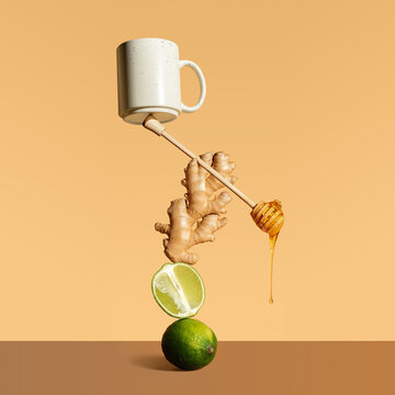 Composition with balancing lime, ginger, tea and honey spoon. Minimalistic poster of Abstract natural composition. Healing tea for colds