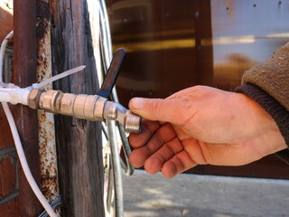checking the thread on the outlet pipe from the outside of a private house, setting up equipment for garden irrigation, plumbing work with street water pipes