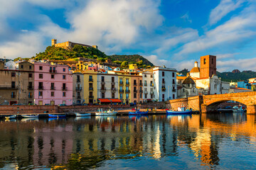 Obraz premium Beautiful view of Bosa town, Sardinia island, Italy. Travel destination. Bosa town with Ponte Vecchio bridge across the Temo river. Marvelous morning view of Sardinia island, Italy, Europe.