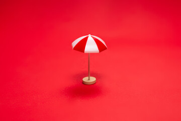 Red umbrella on a red background.