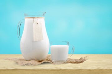 Glass and jug of fresh tasty milk, dairy products