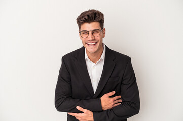 Young business caucasian man isolated on white background laughing and having fun.