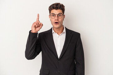 Young business caucasian man wearing headphones isolated on white background having an idea, inspiration concept.