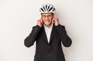 Young business caucasian man holding bike helmet isolated on white background covering ears with hands.