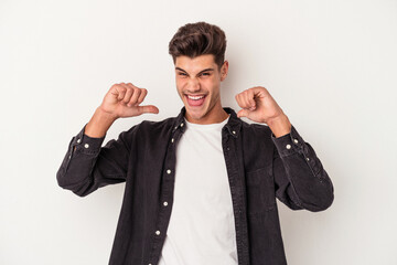 Young caucasian man isolated on white background feels proud and self confident, example to follow.