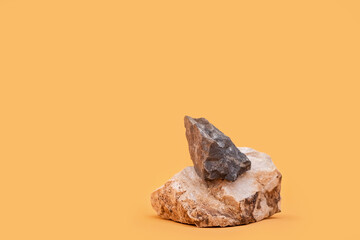 Minimal modern product is shown on a beige background with stones podium