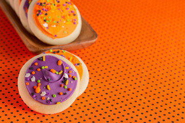 Frosted Icing Sugar Cookies on a Black and Orange Table