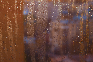 Water rain drops on window glass, closeup view. Color background