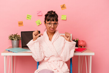 Young mixed race woman preparing a exam in the room wearing pajama isolated on pink background feels proud and self confident, example to follow.
