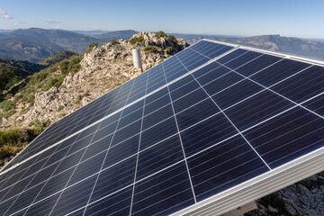 Solar panels on a mountain, on a sunny day.