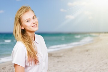 Fototapeta na wymiar Happy young woman feeling the breeze at beach.
