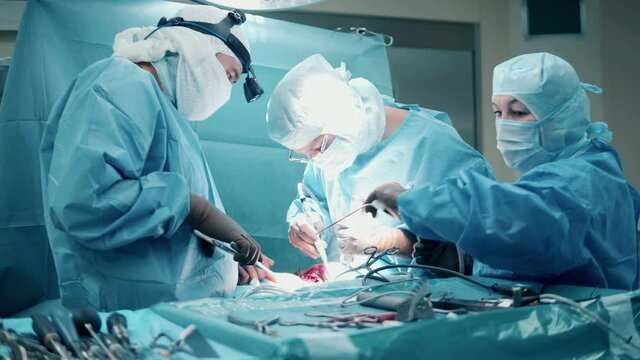 Group of doctors are carrying out a surgery with medical tools
