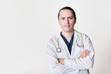 serious latin doctor, crossing his arms on white background with stethoscope