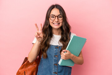 Young caucasian student woman isolated on pink background showing number two with fingers.