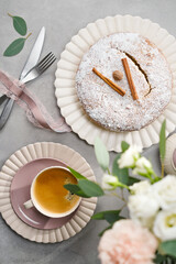 Fresh perfect muffin cake decorated icing sugar with cup of coffee on the granite table. Cozonac or Kozunak in to Romania and Bulgaria. Christmas Stollen traditional German, European Festive Dessert. 