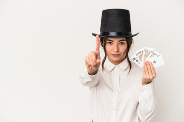 Young magician woman holding a wand isolated on white background showing number one with finger.