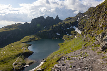 Amazing hiking day in one of the most beautiful area in Switzerland called Pizol in the canton of Saint Gallen. What a wonderful landscape in Switzerland at a sunny day. Beautiful blue alpine lake.