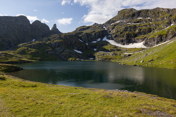 Amazing hiking day in one of the most beautiful area in Switzerland called Pizol in the canton of Saint Gallen. What a wonderful landscape in Switzerland at a sunny day. Beautiful blue alpine lake.