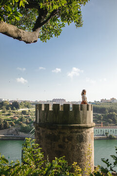happy tourist smiling outdoors at viewpoint crystal palace gardens with view from douro river in Porto Portugal tourist exploring the city during summer and feeling happy and excited