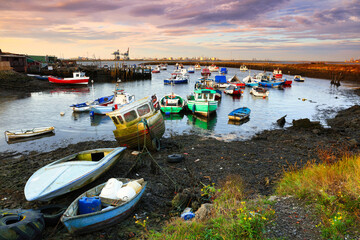 Fototapeta na wymiar Warm Morning Light on Fishing Boats at South Gare, Middlesbrough, North Yorkshire, England, UK.