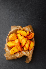 wedges potato in bowl top view. wedges potato on dark concrete table