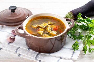 Soup with lentils and vegetables on a light table.