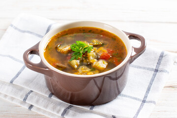 Soup with lentils and vegetables on a light table.