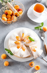 Fresh apricot cheesecake on light background. Top view. Healthy summer dessert concept.