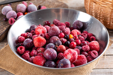 Assortment of frozen berries in a bowl on table. Stocks of food. Frozen Food.