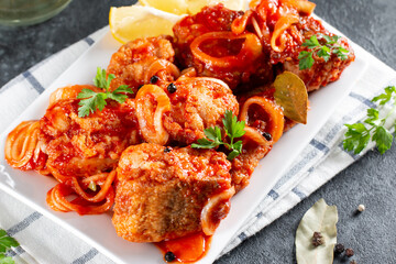 Close up deep fried grouper fish spicy sweet and sour sauce.