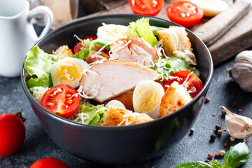 Chicken salad. Chicken Caesar Salad. Caesar salad with smoked chicken on a plate. Grilled chicken breasts and fresh salad