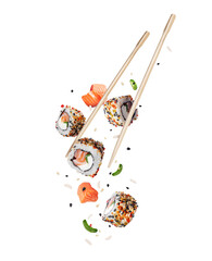 Fresh sushi with salmon and ingredients in the air isolated on white background