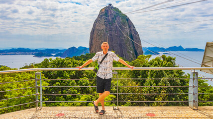 Tourist traveler poses at Sugarloaf mountain Rio de Janeiro Brazil.