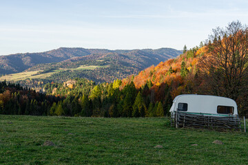 abandoned caravan on grassland at autumn