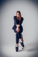 the model is sitting on a chair in studio