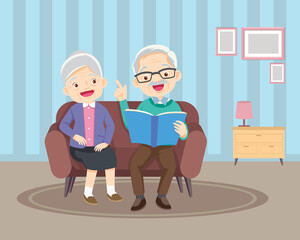 elderly reading book together on sofa