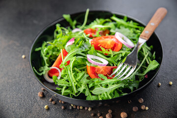 salad fresh vegetable arugula, tomato, onion plate meal snack on the table copy space food background 