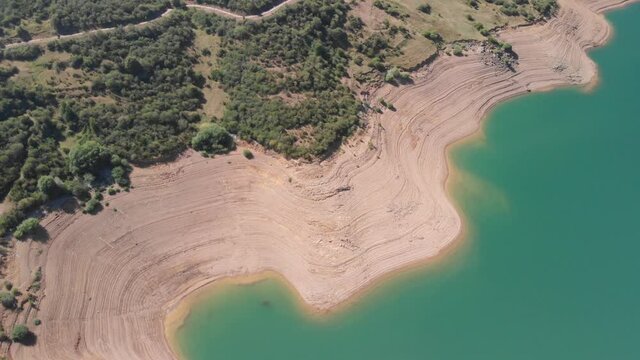 Aerial aerial drone shot of a swamp. The lake shines on a sunny day with the hills outlining its clear waters