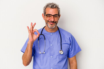 Middle age nurse caucasian man isolated on white background  cheerful and confident showing ok...